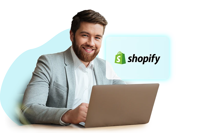 Smiling man sitting at a laptop doing Shopify development for Australian e-commerce businesses.